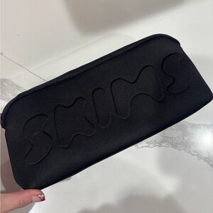 SKIMS Black Embossed Pouch